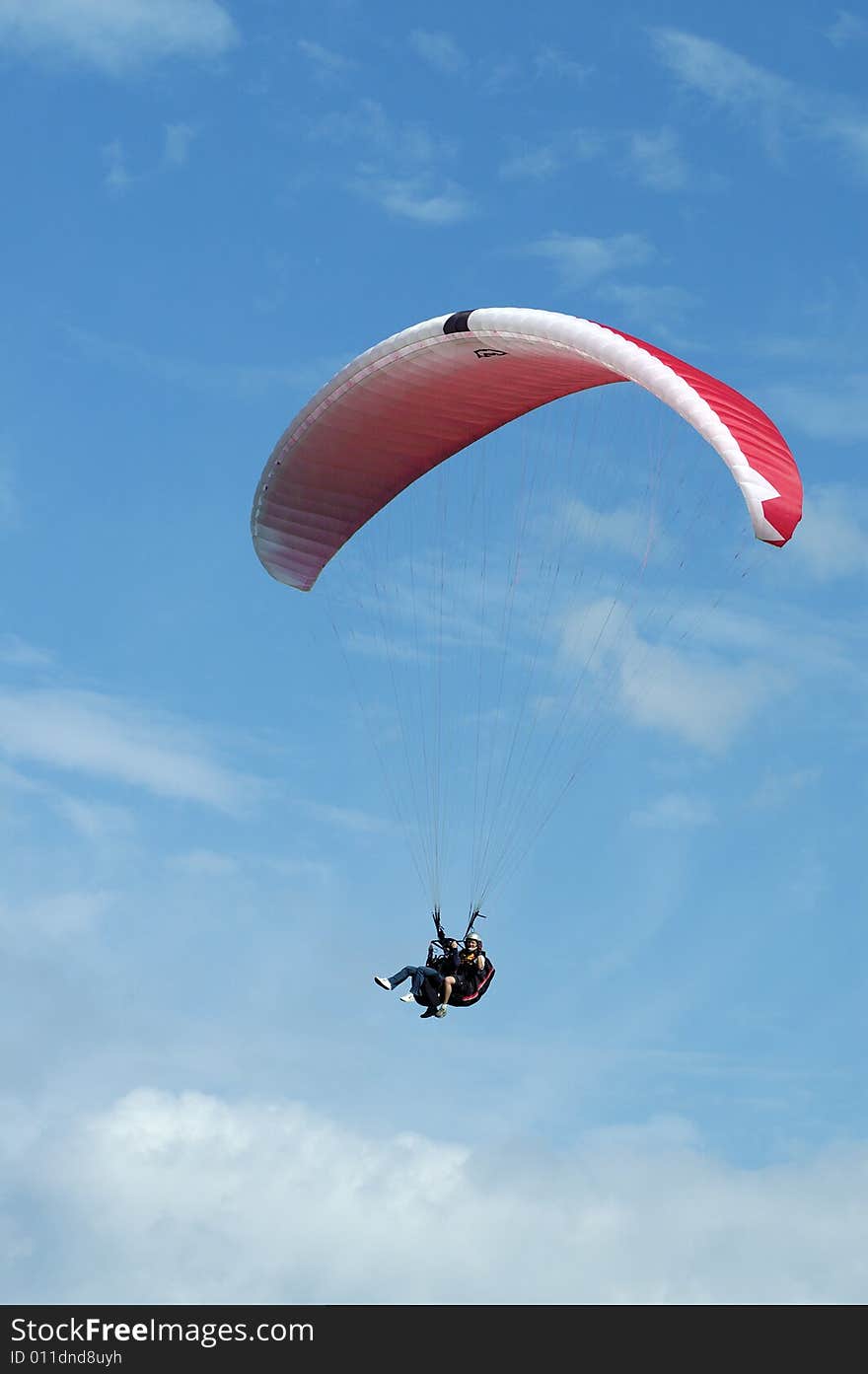 Tandem paragliding in cloudscape area