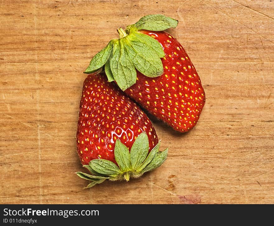 Fresh and tasty strawberries isolated on wooden background. Fresh and tasty strawberries isolated on wooden background