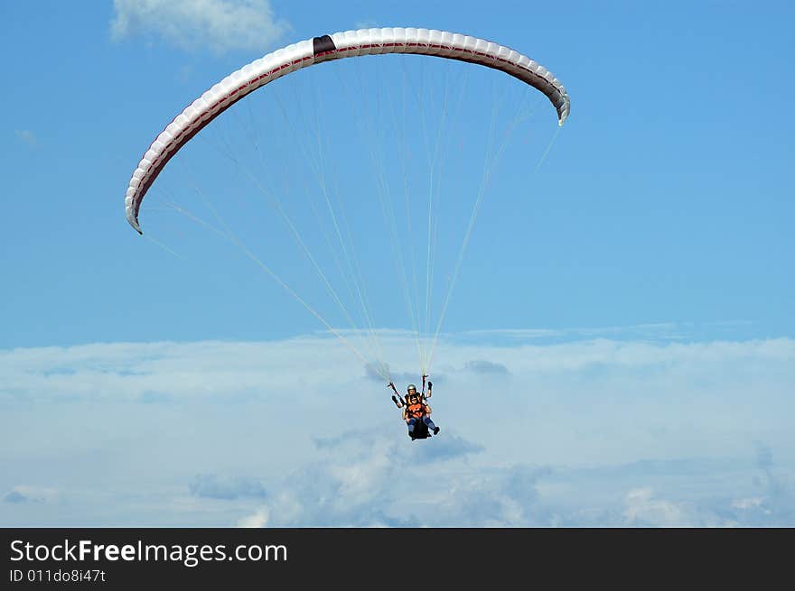 Tandem paragliding in cloudscape area