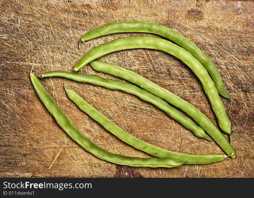 Green beans on wooden table, studio shot. Green beans on wooden table, studio shot.