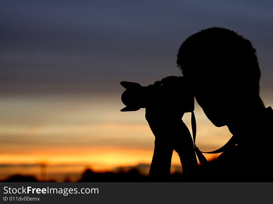 Photographer with sunset in the background. Photographer with sunset in the background