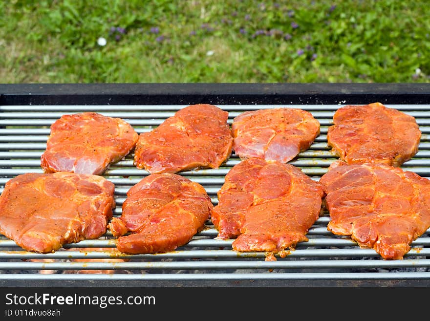 Barbecued steak on the grill. Barbecued steak on the grill.