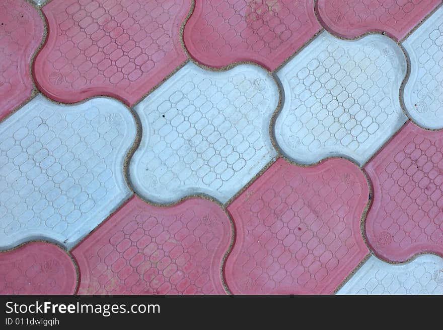 Close-up of new old-style pavement of figured stoneblocks (bricks) of red and light color