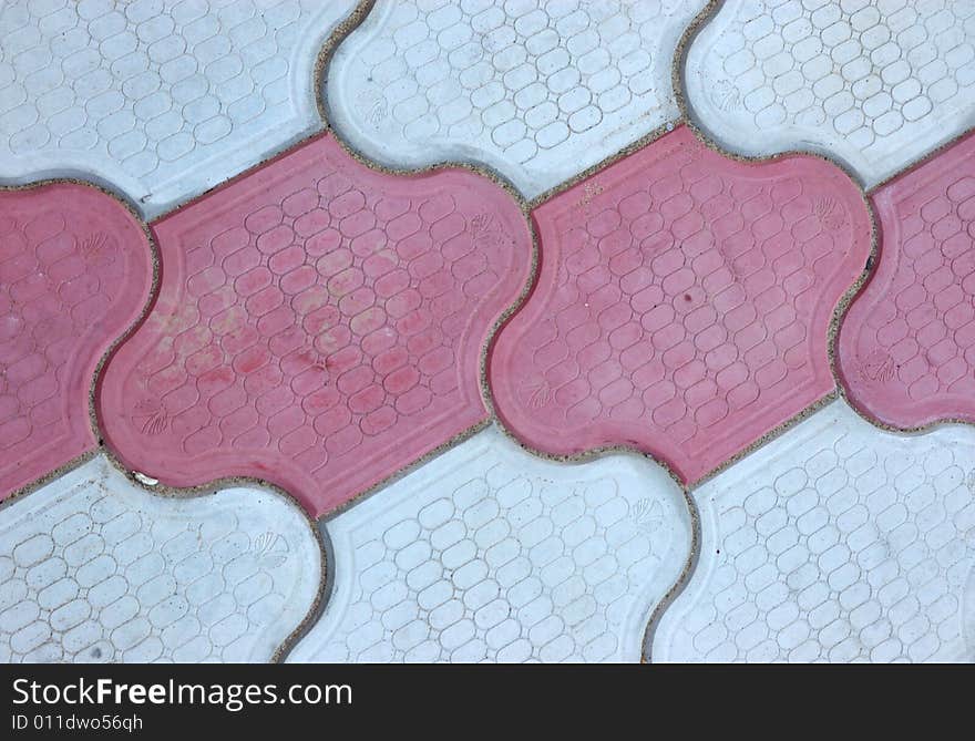 Close-up of new old-style pavement of figured stoneblocks (bricks) of red and light color