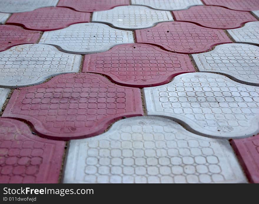 Close-up of new old-style pavement of figured stoneblocks (bricks) of red and light color