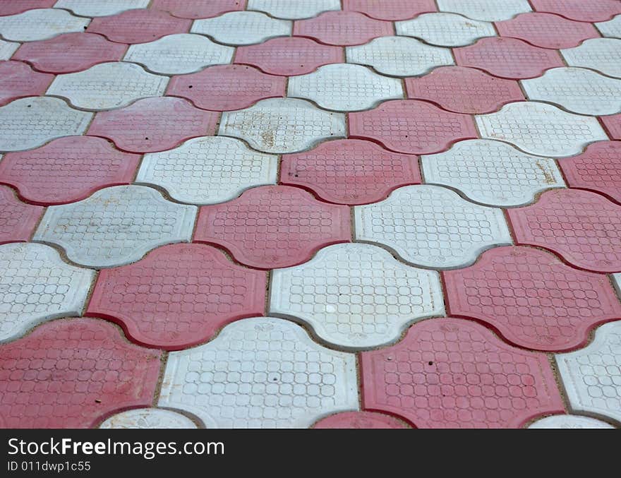 Close-up of new old-style pavement of figured stoneblocks (bricks) of red and light color