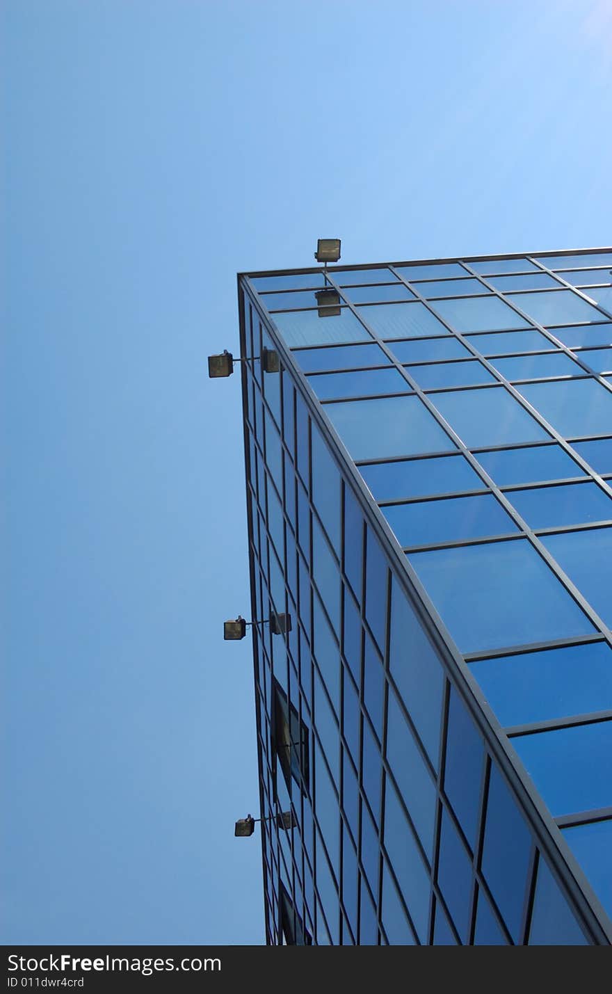 View of new modern office building of steel and glassagainst sky. View of new modern office building of steel and glassagainst sky