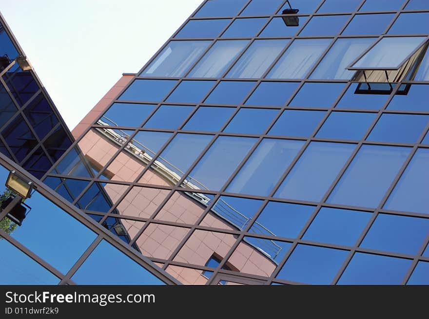 View of new modern office building of steel and glassagainst sky. View of new modern office building of steel and glassagainst sky