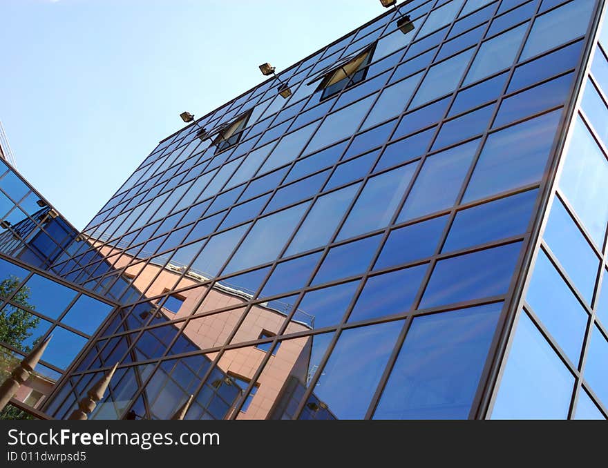 View of new modern office building of steel and glassagainst sky. View of new modern office building of steel and glassagainst sky