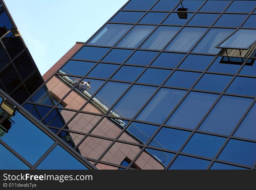 View of new modern office building of steel and glassagainst sky. View of new modern office building of steel and glassagainst sky