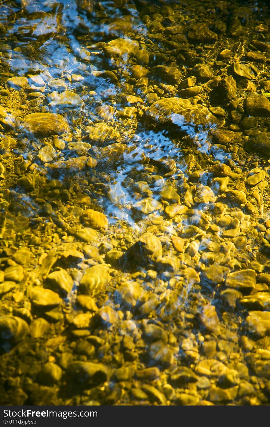 Riverbed with rock bottom in afternoon light