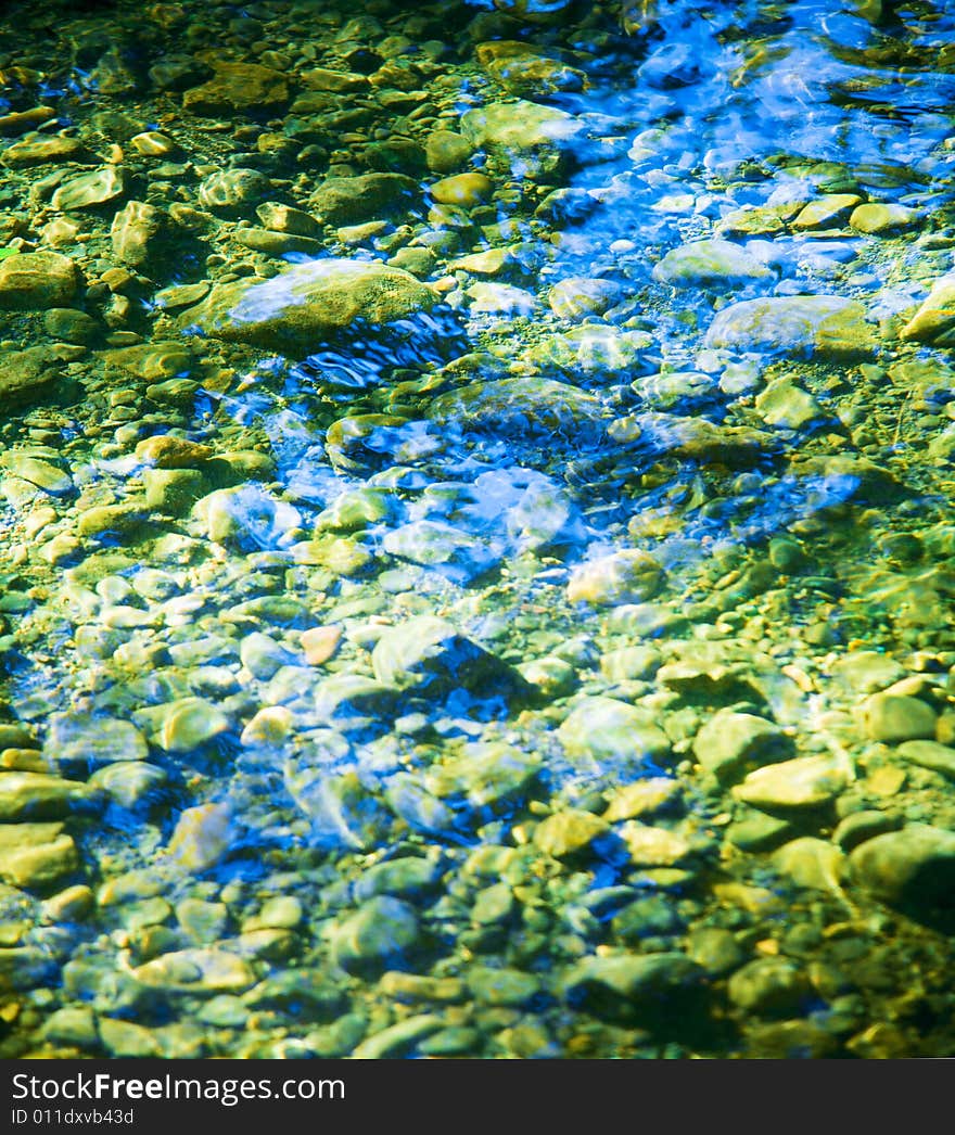 Riverbed with rock bottom in afternoon light