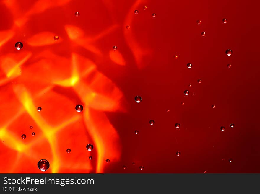 Drops of water on a red background. Drops of water on a red background.