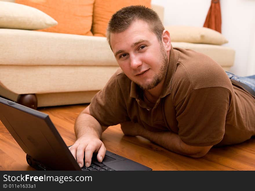 Happy man on sofa with laptop. Happy man on sofa with laptop