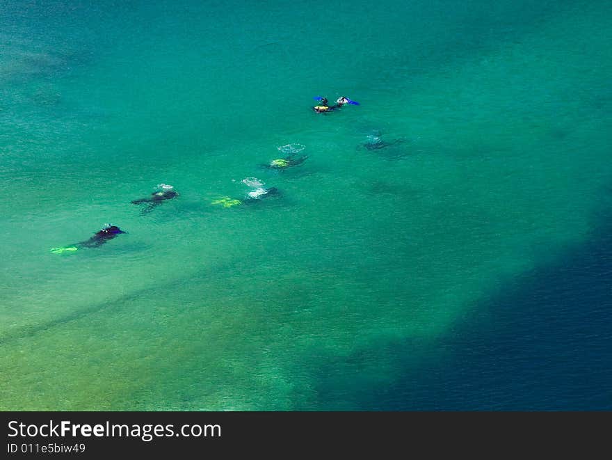 Divers descending to the blue water. Divers descending to the blue water