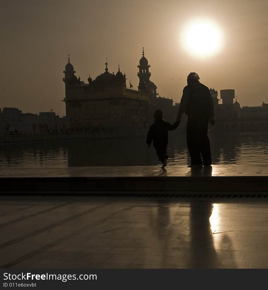 Father ans son walking to Golden Temple, Sunrise. Father ans son walking to Golden Temple, Sunrise