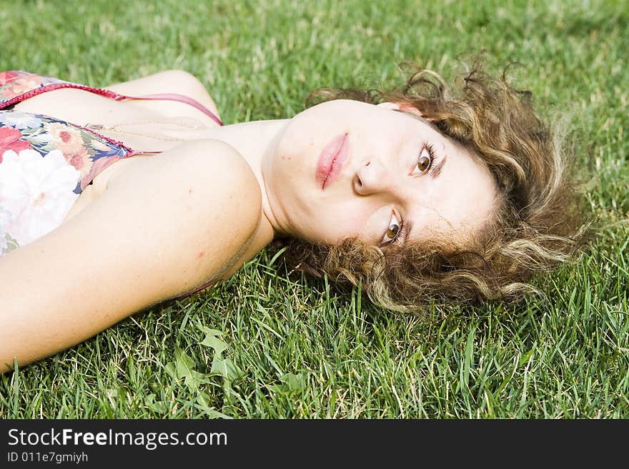 Girl lying on green grass