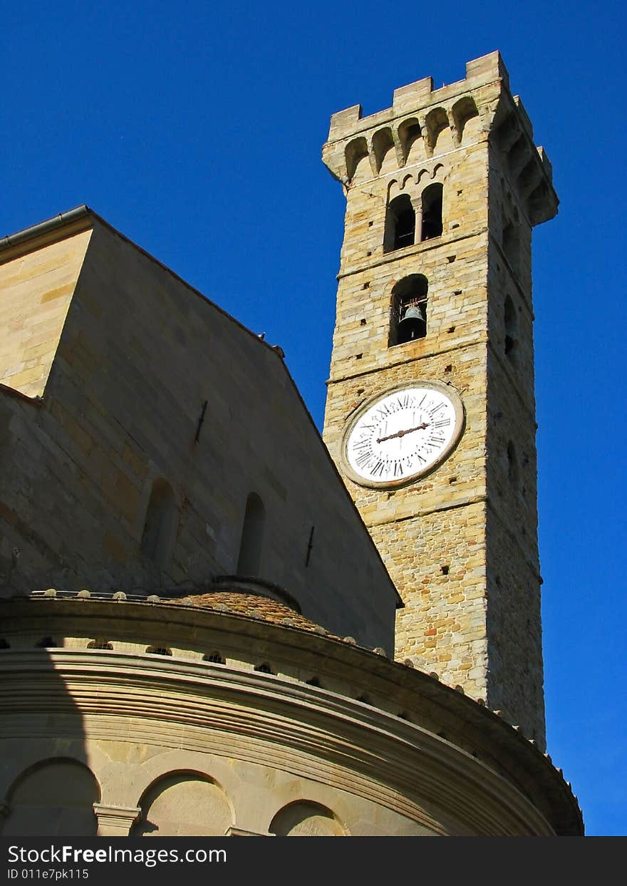 A medieval, renaissance bell and clock tower at the basilica in San Gimignano, Italy in Tuscany. A medieval, renaissance bell and clock tower at the basilica in San Gimignano, Italy in Tuscany.