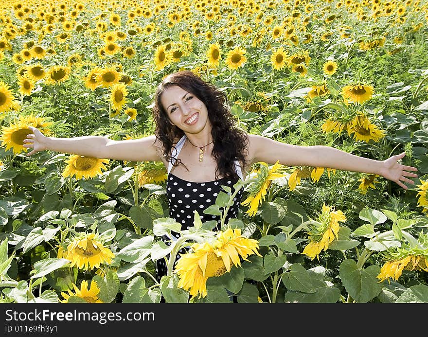 Happy girl in field of sunflowers