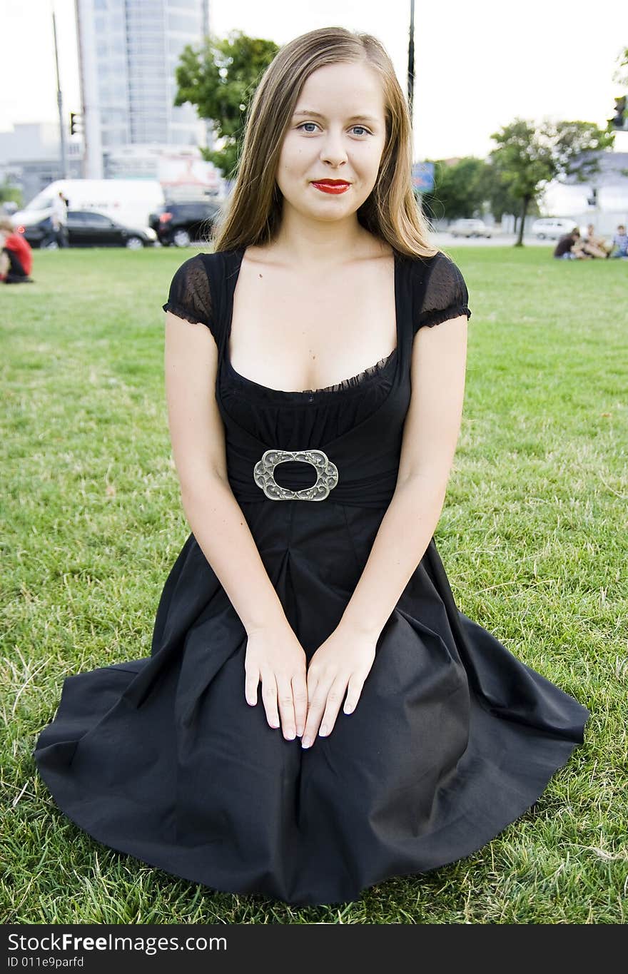 Smiling girl in dress on grass