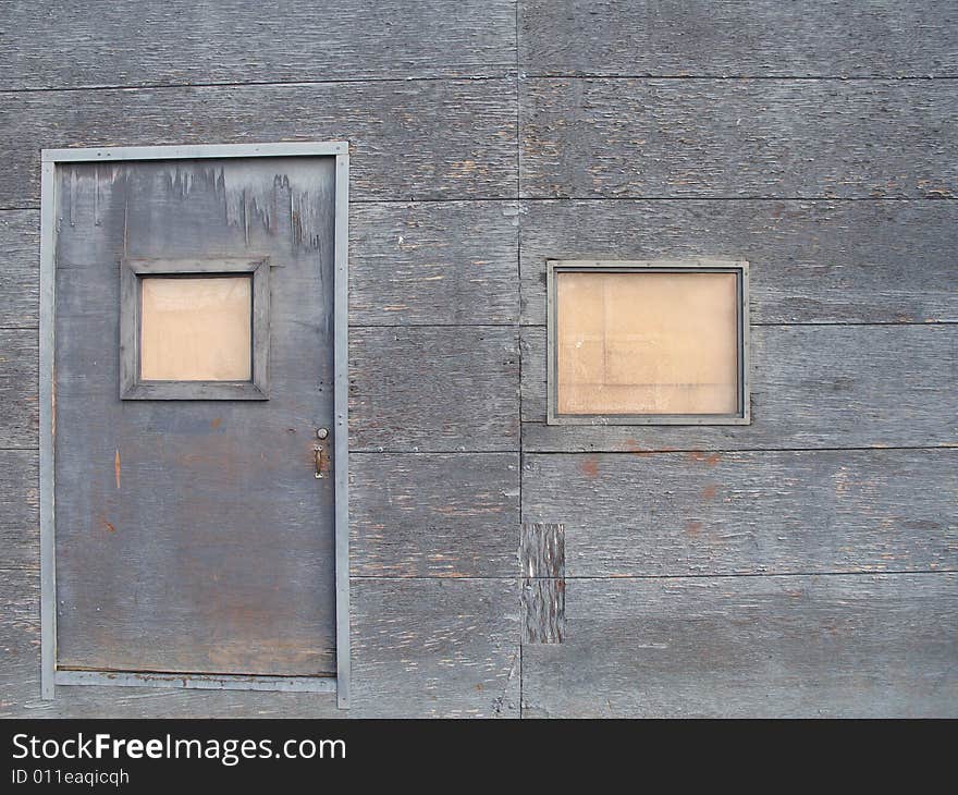 Old grey barricaded door