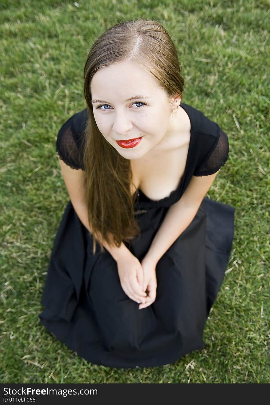 Smiling girl on green grass