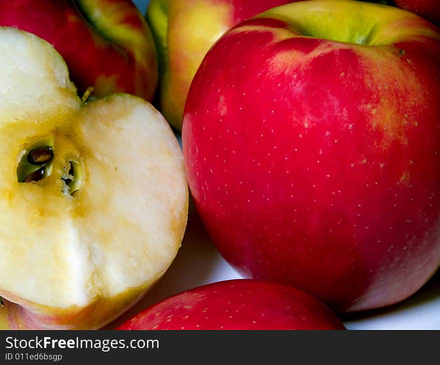 A small pile of fresh cut green and red apples. A small pile of fresh cut green and red apples