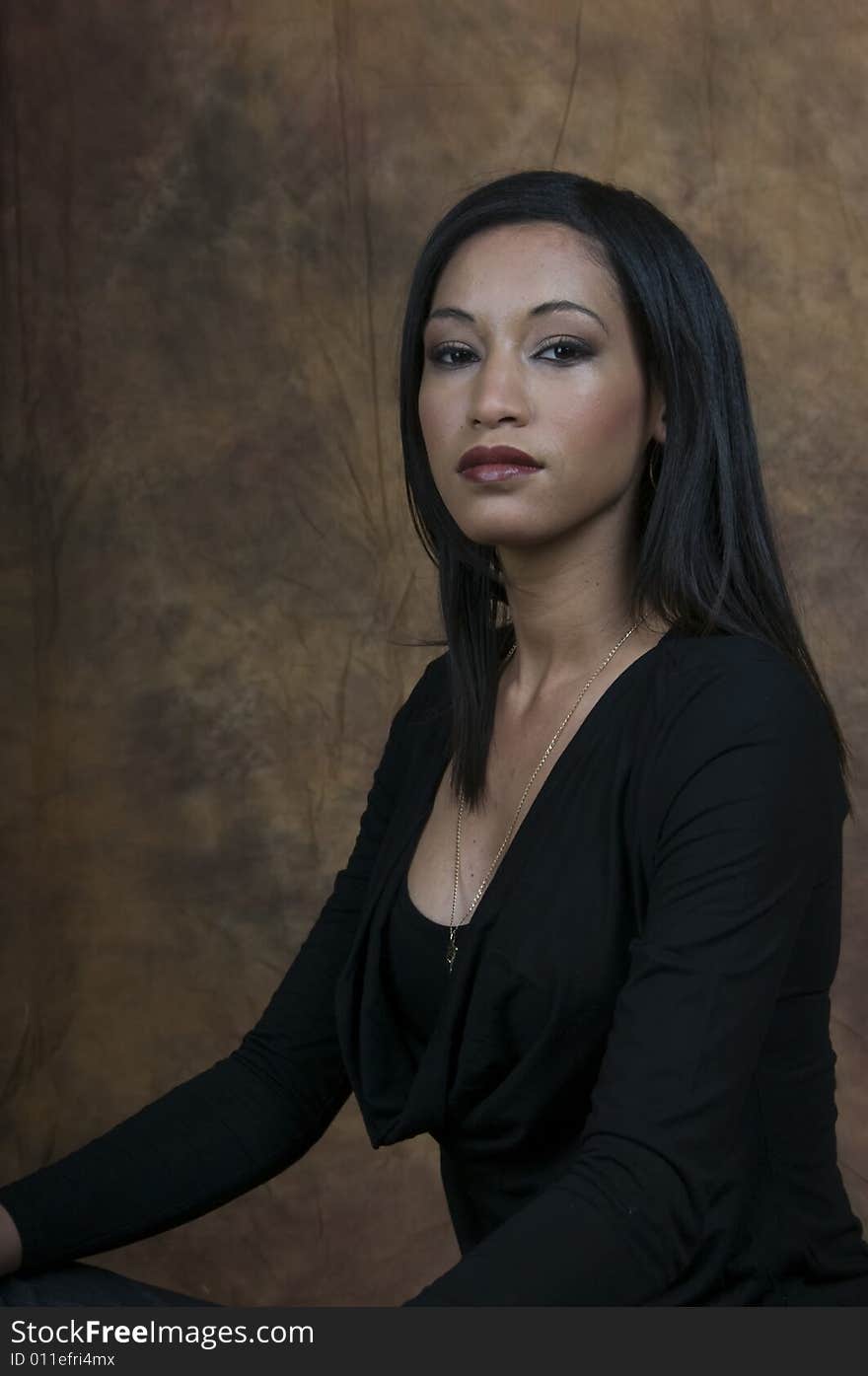 A head and shoulders of a young lady sitting side on looking at camera. A head and shoulders of a young lady sitting side on looking at camera.