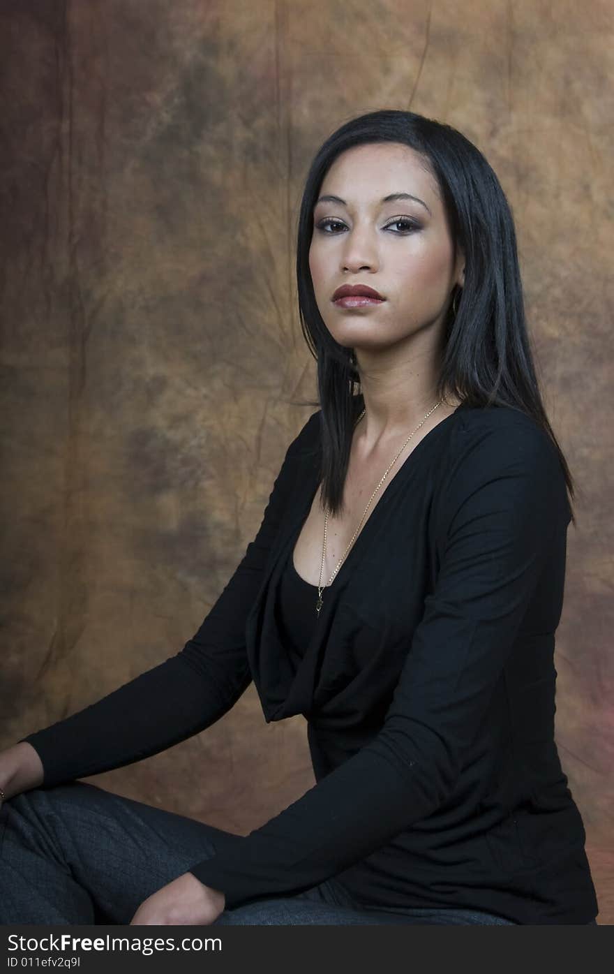 A head and shoulders of a young lady sitting side on looking at camera. A head and shoulders of a young lady sitting side on looking at camera.