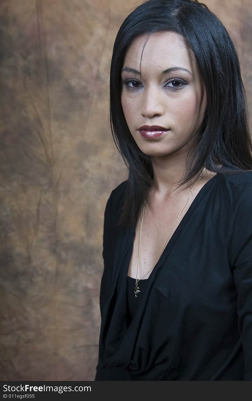 A head and shoulders of a young lady sitting side on looking at camera. A head and shoulders of a young lady sitting side on looking at camera.