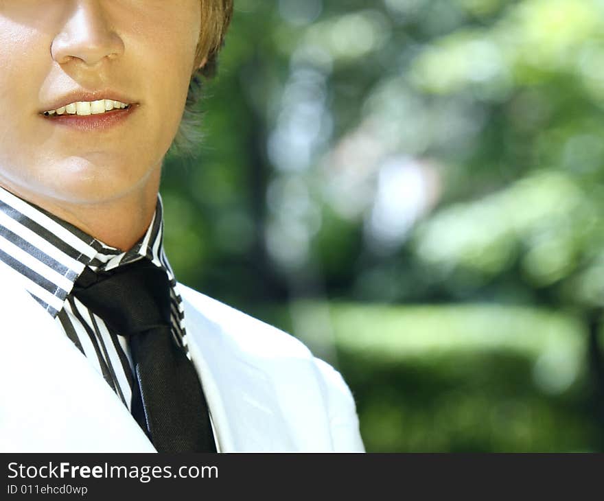 Close Up Of A Beautiful Smile And A Black Tie