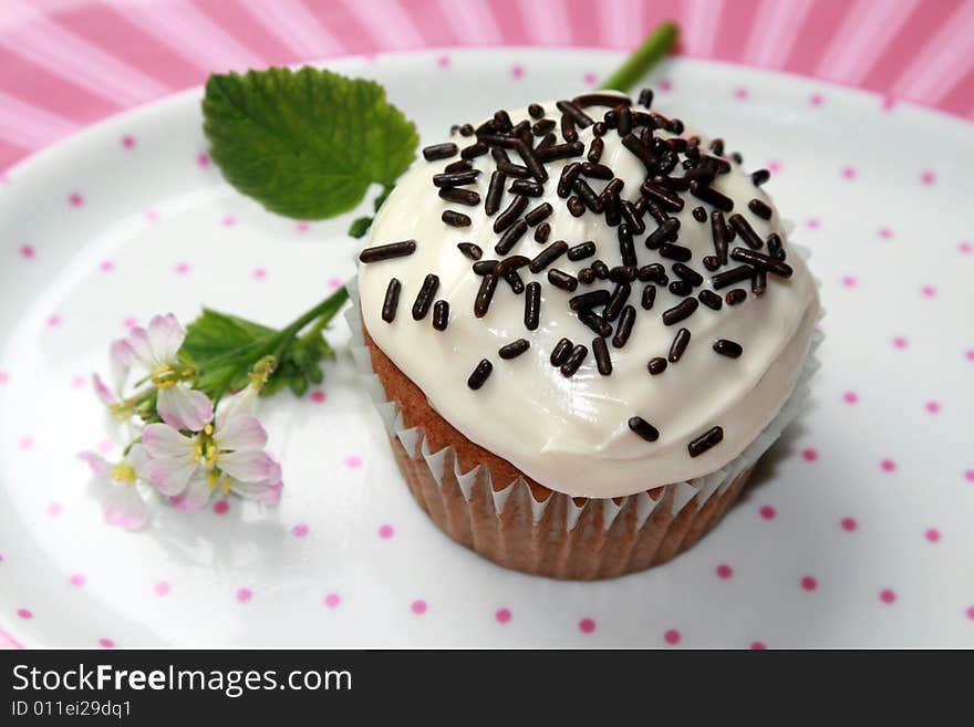 A birthday cupcake on a plate.