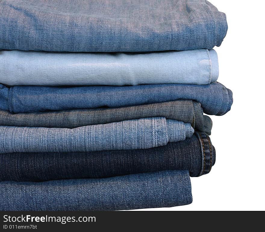 Stack of blue and black jeans over white with clipping path. Stack of blue and black jeans over white with clipping path