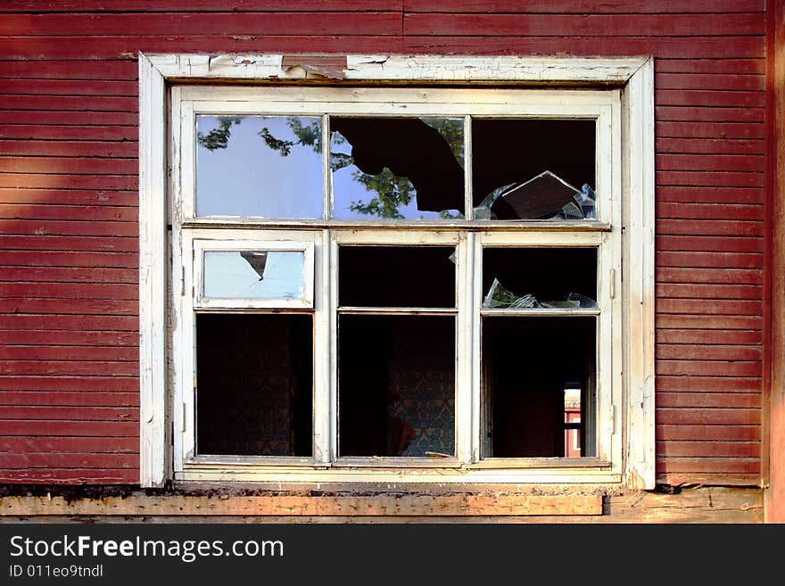 Dilapidated wooden building with a broken window. Dilapidated wooden building with a broken window