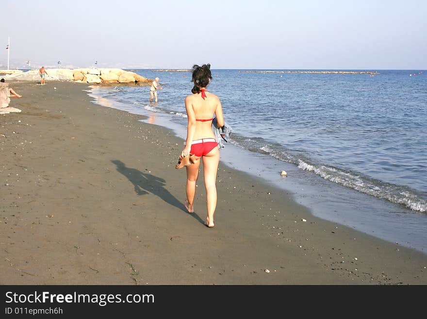 Pretty girl in red bikini on the beach.