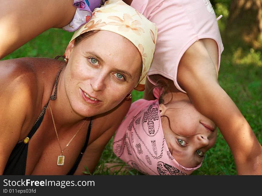 Mother and daughter on the nature in sunny summer day