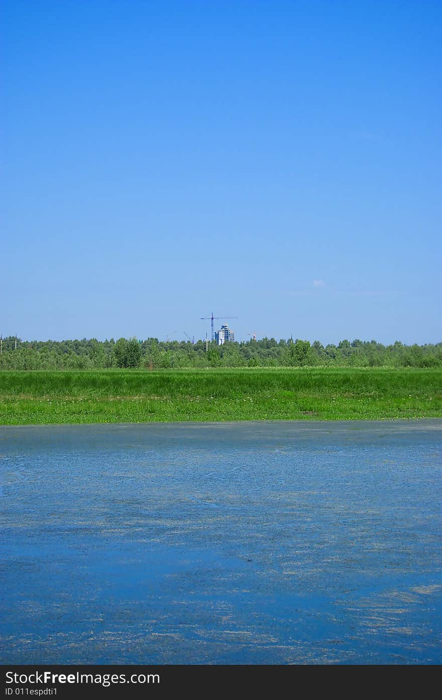 Construction works on skyline, bog in the foreground. Construction works on skyline, bog in the foreground