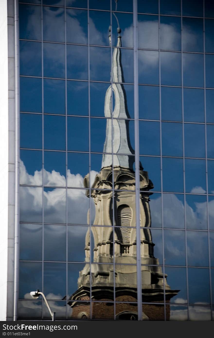 Reflection of a church in building windows