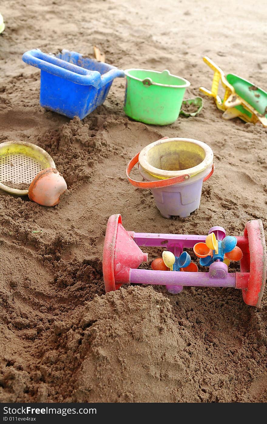 Children's toys in sand pool.