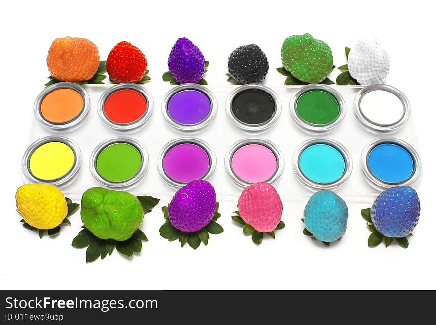 Colorful strawberry and eyeshadow on white background.