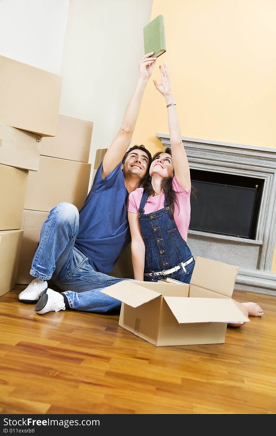 Young couple being silly with moving boxes at home. Young couple being silly with moving boxes at home