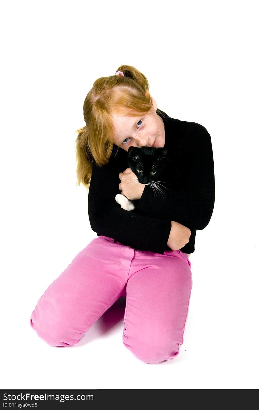 Girl is holding young kitten isolated