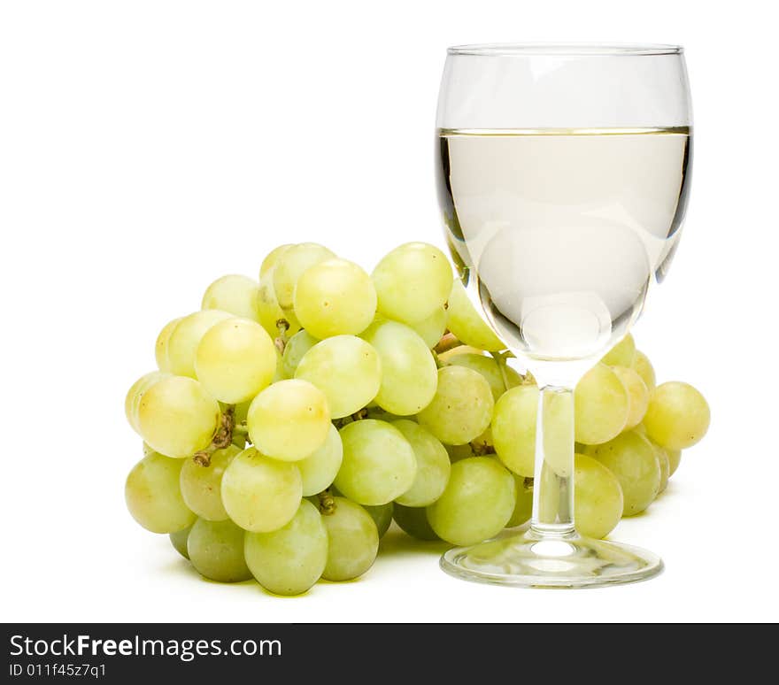 Wine in a glass and grapes on a white background