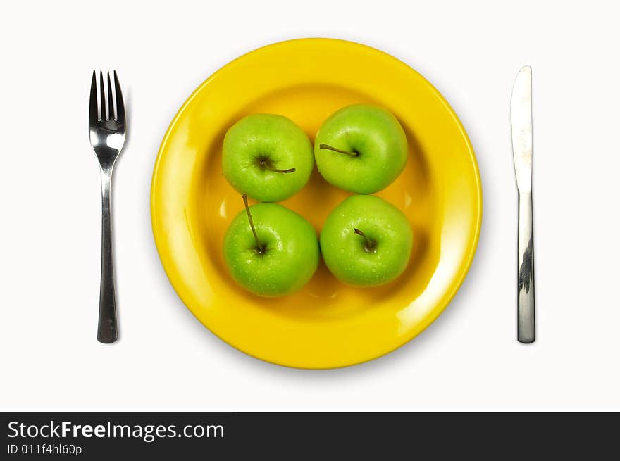 Green apples  in yellow plate on white background. Green apples  in yellow plate on white background