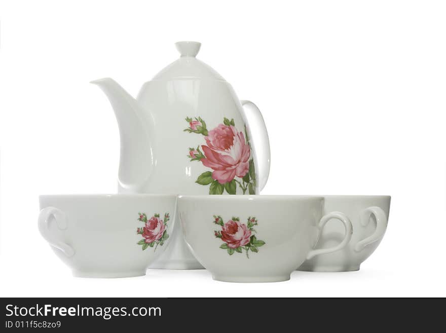 White tea set with flowers consisting of teapot and 3 teacups, isolated, with clipping path, on white background. White tea set with flowers consisting of teapot and 3 teacups, isolated, with clipping path, on white background