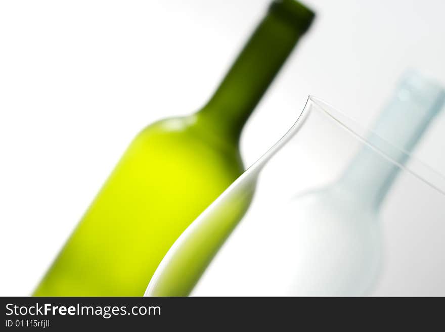 Close-up of white and green bottle with glass. Close-up of white and green bottle with glass