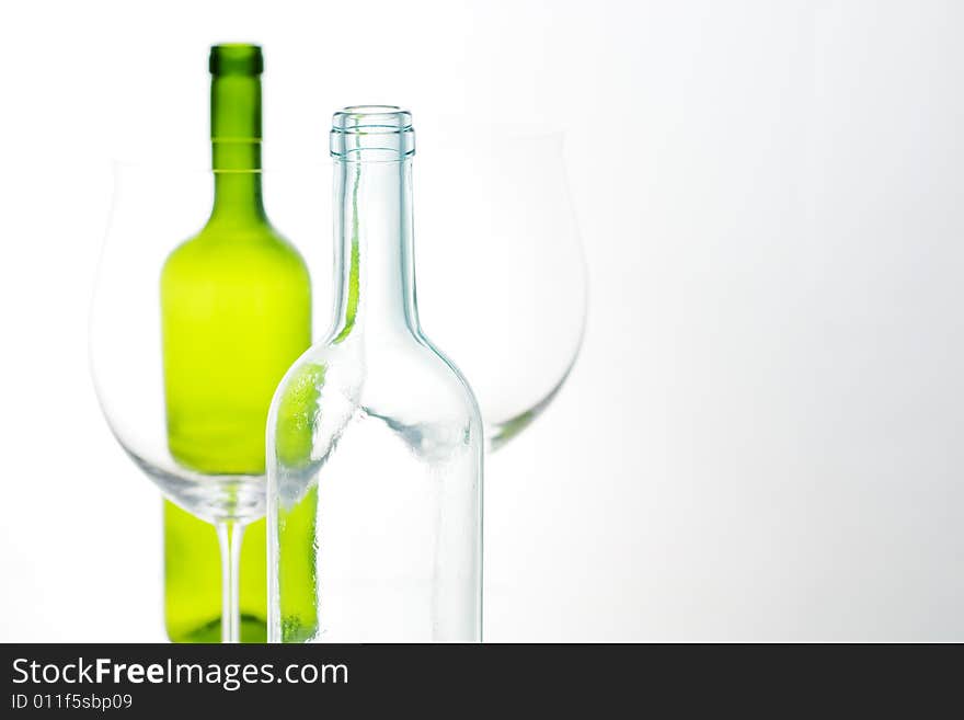 Close-up of white and green bottle with glass. Close-up of white and green bottle with glass