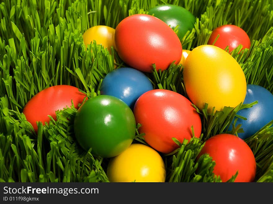 Yellow, red, blue and blue Easter Eggs in Grass