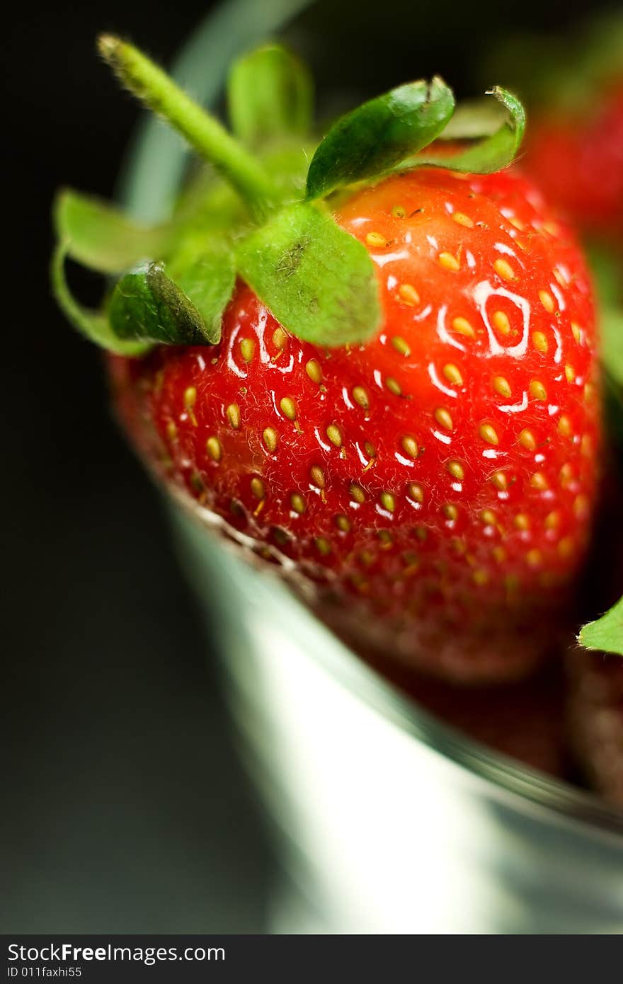 Strawberry in glass on black background. Strawberry in glass on black background