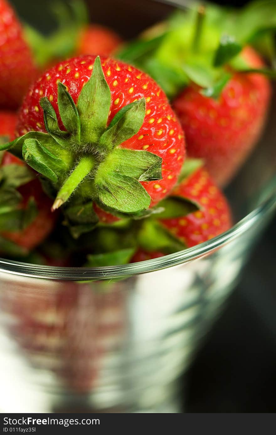 Strawberry in glass on black background. Strawberry in glass on black background